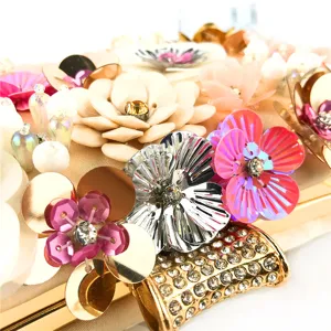 Handcrafted floral beaded evening clutch bag detail view, luxury rhinestone clasp and colorful petals.