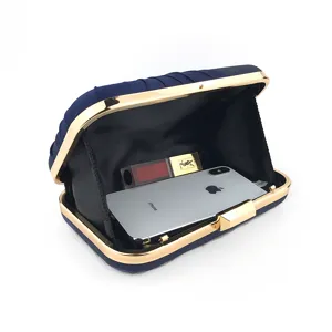 Navy blue pleated evening clutch bag with gold metallic frame, showcasing spacious interior.