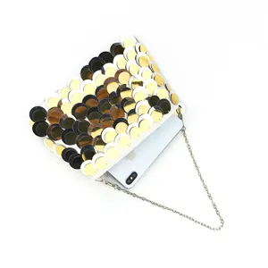 Sequin clutch bag detail showing gradient scales design and delicate metal chain strap.
