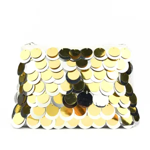 Detailed shot of a gorgeous sequin evening clutch bag with shimmering gold and silver scales.