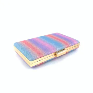 Close-up detail of a glittering rainbow clutch bag with a sleek gold-tone metal frame.