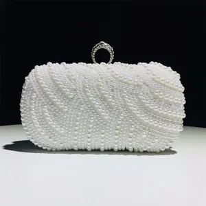 Pearl evening clutch bag detail showing exquisite handmade pearl beading and sparkly ring clasp.