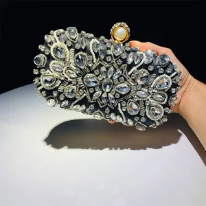 Detail shot of black rhinestone beaded evening clutch bag with pearl clasp for party