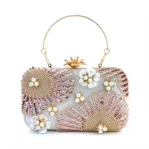 Elegant evening clutch bag with sequin beadwork and pearl floral accents for weddings.