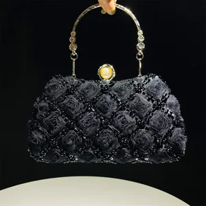 Handmade beaded evening bag detail, floral textured fabric, elegant metal ring handle and clasp.