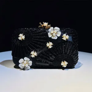 Exquisite black sequin evening clutch bag featuring elegant pearl flowers and beaded details.