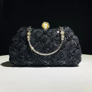 Elegant black beaded evening clutch bag with exquisite handmade floral lace design and pearl clasp.