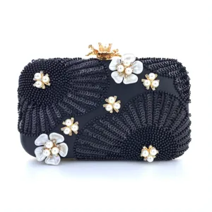Exquisite black sequin evening clutch bag with stunning pearl and crystal floral details.