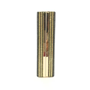 Detailed view of rhinestone clutch bag, featuring gold metal frame and black stripes.