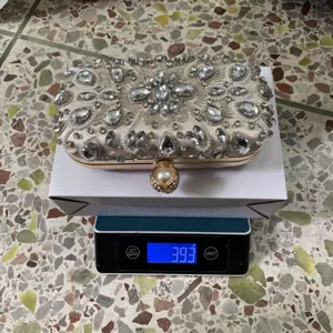 Rhinestone evening clutch bag for women, luxury beaded wedding party handbag with metal frame.