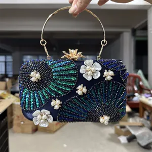 Exquisite beaded evening clutch bag with sequin floral design and metal ring handle for events.