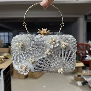 Detailed view of handmade beaded sequin evening clutch bag with pearl floral appliques.