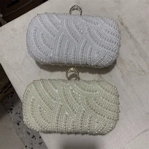White and beige pearl evening clutch bags with sparkling ring clasps, elegant party purses.