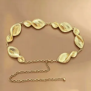 Close-up detail of the gold metallic waist chain featuring stylish twisted leaf links and chain.
