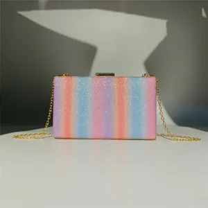 Colorful glitter evening clutch detail view, rainbow gradient hard shell design, gold chain