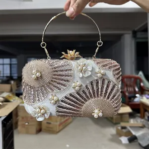 Elegant sequin pearl evening clutch bag with metal ring handle for wedding party events.