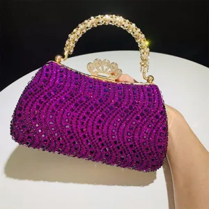 Bolso de noche de estrass morado con cierre de corona dorada y asa brillante elegante.