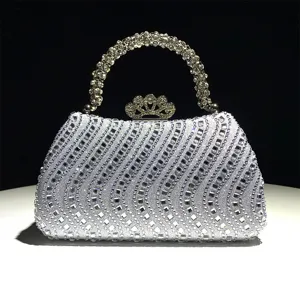 Elegante bolso de noche de diamantes de imitación con asa brillante y cierre de corona.