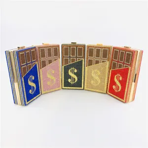 Detailed view of the sparkling rhinestone chocolate bar design evening clutch bag with dollar sign.