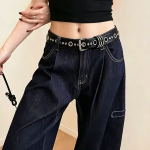 Punk style women black leather belt with metal grommets and rings, edgy fashion accessory.