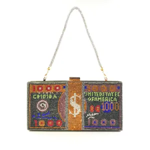 Close-up detail of a glamorous rhinestone clutch bag designed with dollar bill theme.