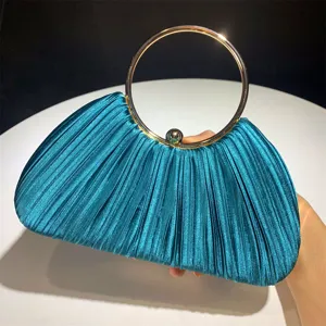 Elegant pleated satin evening clutch bag with a luxurious round gold handle for parties.