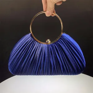 Blue satin pleated evening clutch bag detail, elegant gold metal round handle for party wear.
