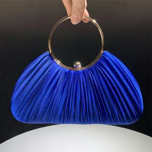 Detailed view of the royal blue pleated evening clutch with elegant gold round ring handle.