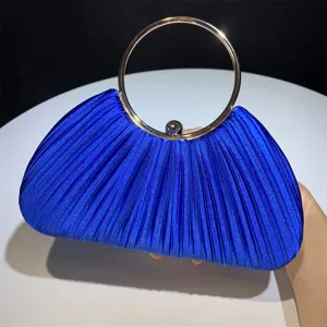 Details of the blue satin pleated evening clutch handbag featuring a gold metal ring handle.