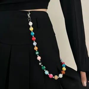 Close-up detail of a colorful mini billiard ball pants chain, trendy hip-hop waist accessory.