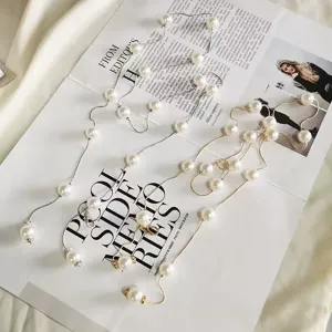 Exquisite pearl chain belt detail close-up, stylish tassel pendant accessory for women.