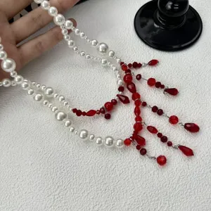 Gothic red pearl and crystal tassel waist chain detail shot, niche design double layer belt.