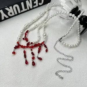 Detailed close-up of gothic dark style red pearl and crystal beaded fringe layered waist chain.
