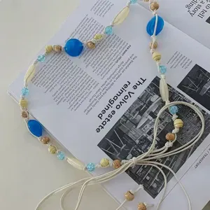 Bohemian blue beaded braided waist chain detail, ethnic style tassel belt accessory.