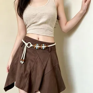 Bohemian woven waist chain with wooden beads and shell accents, perfect summer accessory.