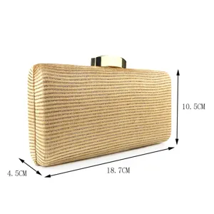 Gold glitter evening clutch bag detail view, stylish fabric party purse for women and formal events.