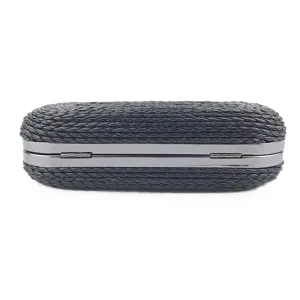 Black woven clutch evening bag women metal frame detail closeup view fashion accessory.