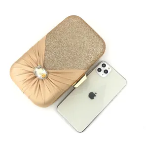 Rhinestone evening clutch bag detail, gold glitter satin design with crystal buckle.