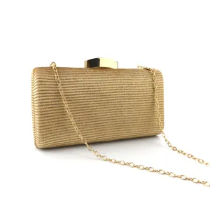 Gold sequin evening clutch bag detail, elegant party handbag hardware lock and chain strap.