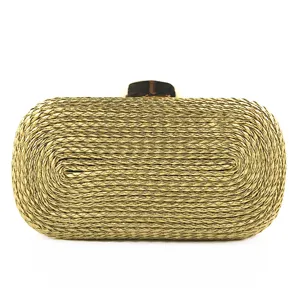 Gold woven clutch bag detail view, elegant evening handbag with metallic clasp closure.