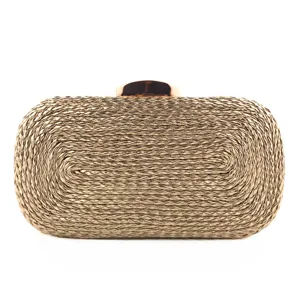 Close-up view of the detailed metallic woven texture and clasp on the elegant evening clutch bag.