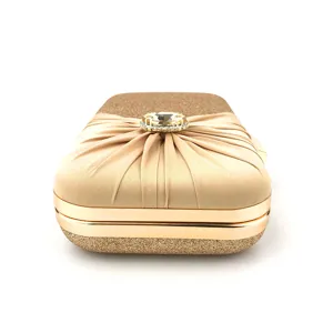 Champagne gold evening clutch bag detail, pleated satin with crystal rhinestone centerpiece.