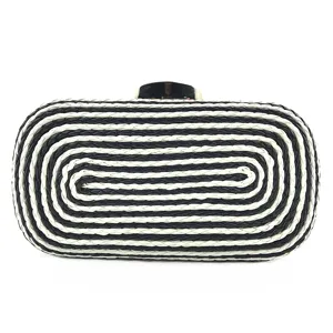 Detailed view of black and white woven PU leather women evening clutch bag with metal clasp.