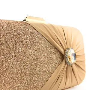 Gold glitter evening clutch bag detail shot, pleated satin and crystal rhinestone decoration.