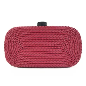 Red woven PU leather clutch bag detail shot, elegant evening handbag with black clasp.