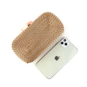 Detailed view of the woven clutch bag texture, showcasing fine craftsmanship and elegant clasp.