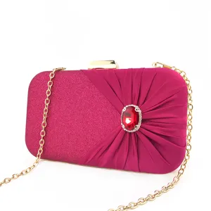 Elegant magenta rhinestone evening clutch bag with gold chain strap for luxury party.
