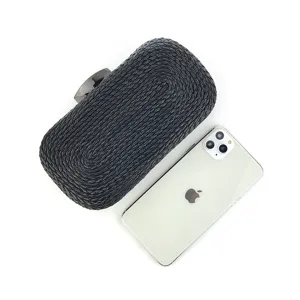 Detailed view of a black hand-woven PU leather clutch bag with metal clasp for women evening parties.