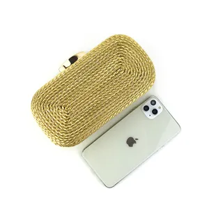 Detailed view of the elegant golden woven clutch bag, showcasing fine craftsmanship.