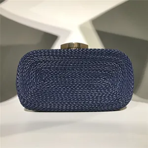 Details of dark blue handmade woven women evening clutch bag with metal clasp, exquisite texture.
